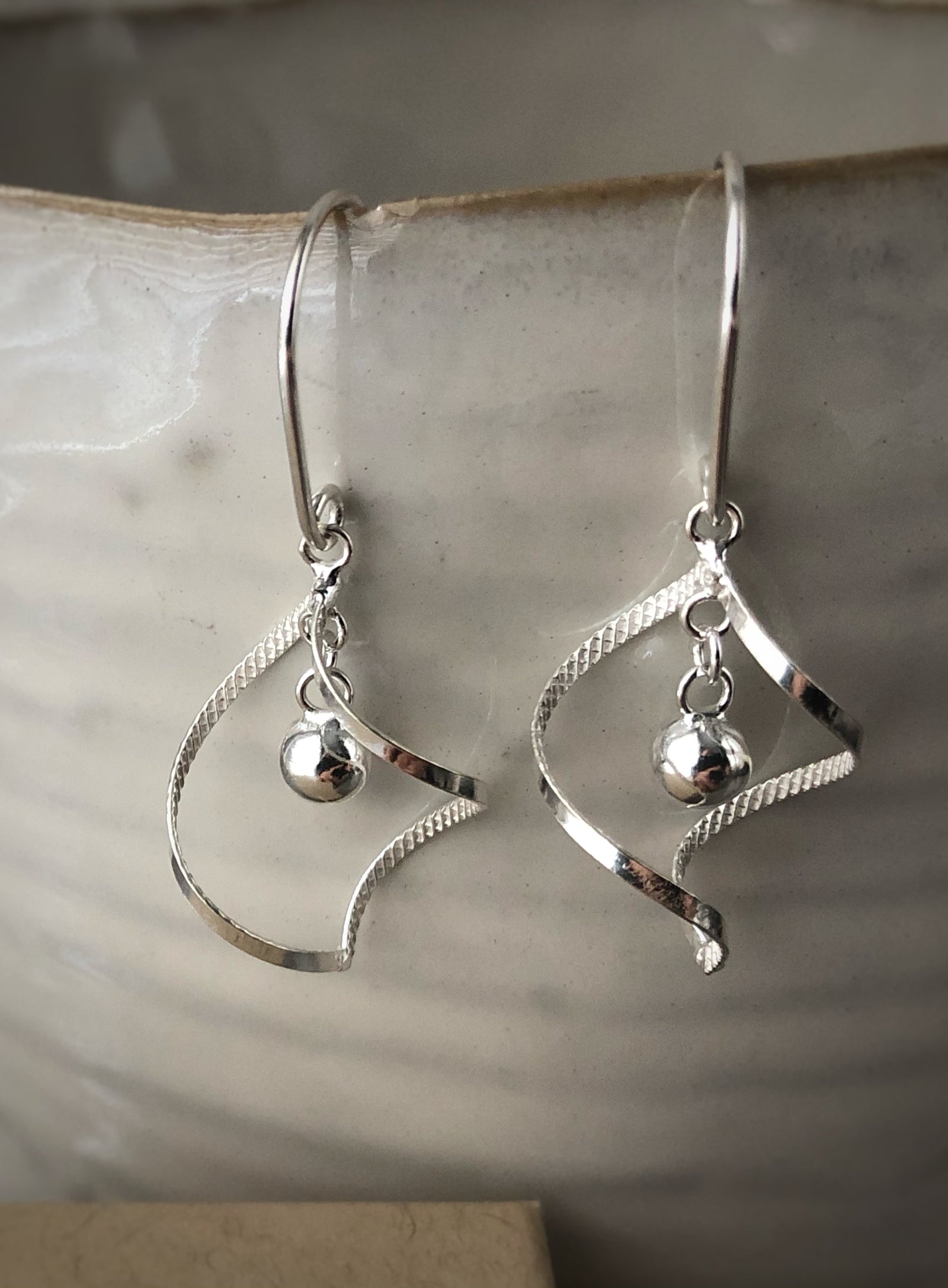 Sterling Silver Elegant Spiral with Hanging Ball Earrings Tiger Lily London